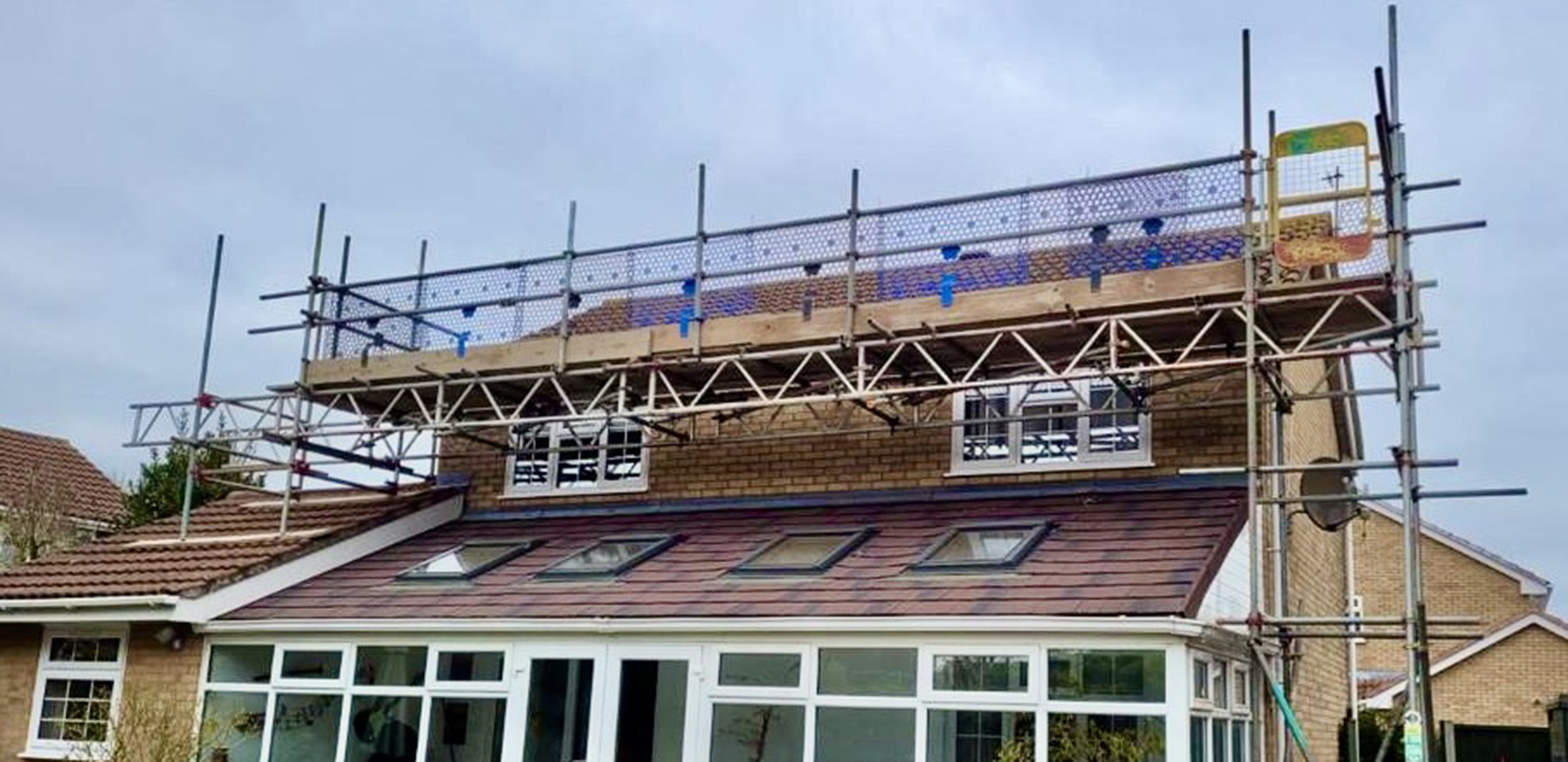 House with Scaffolding Over Roof